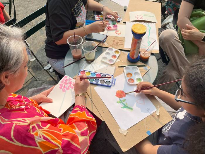 Students participating in a watercolor workshop at the Art Cart in Bryant Park