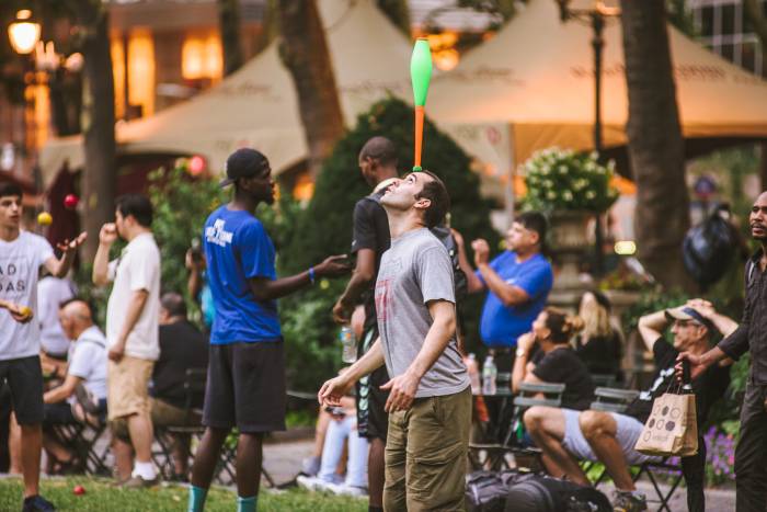 Jugglers with visitors on the lawn during the Intersect event at Bryant Park NYC.