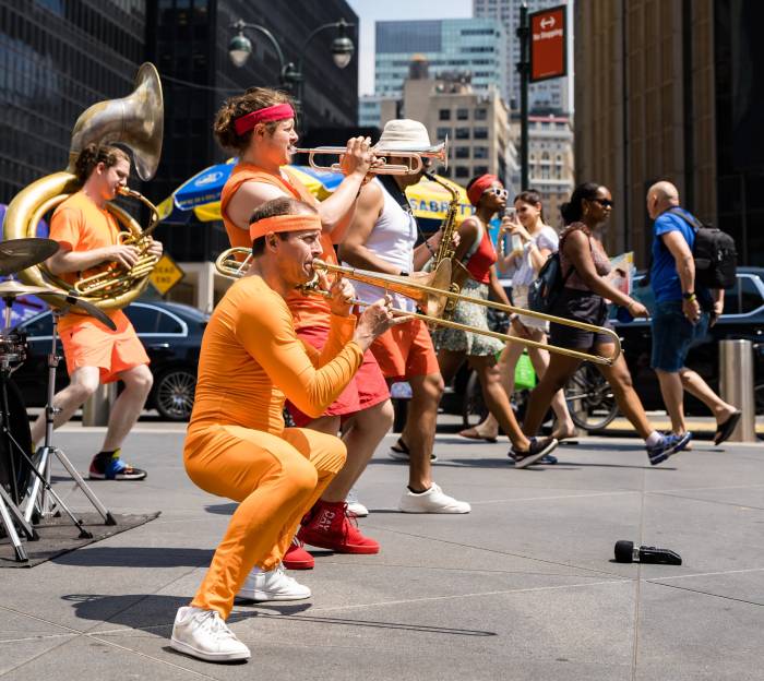 Triad Brass plays in front of Penn Station in Midtown