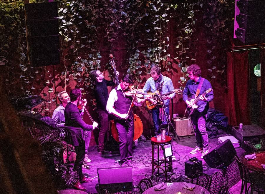 String players from Sedi Donka on a flowery stage.