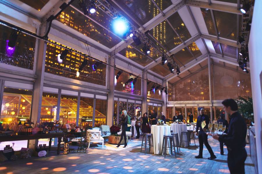 People browse, dine and enjoy a holiday party in the Winter Village at Bryant Park event space.
